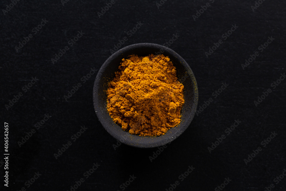 Turmeric curcuma powder in bowl Turmeric curcuma powder in bowl