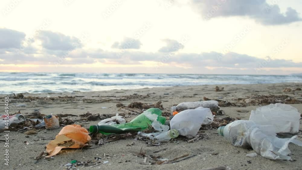Plastic bottles discarded on pollution dump contaminated ocean sea coast,sunset time,environmental waste Plastic bottles discarded on pollution dump contaminated ocean sea coast,sunset time,environmental waste