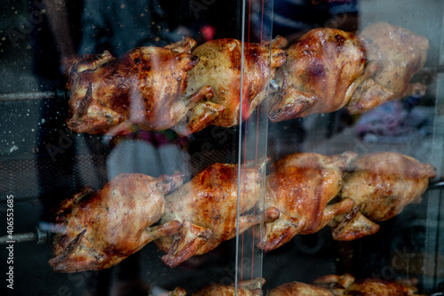 Shot of chickens being grilled on a spit photo