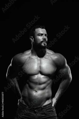 Fitness male model standing on black background