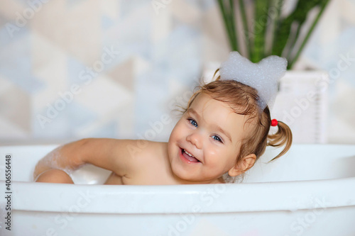 happy baby bathes in the bathroom