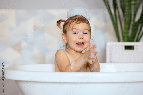 happy baby bathes in the bathroom