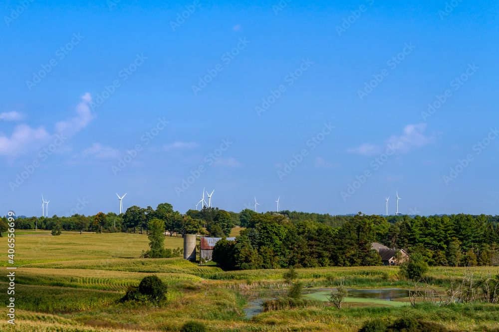 Rural landscape with barn in rural Ontario, Canada, with Wind turbines in the horizon