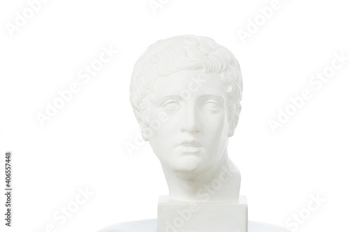 Brightly lit white marble head of young man over white background. On a square pedestal.