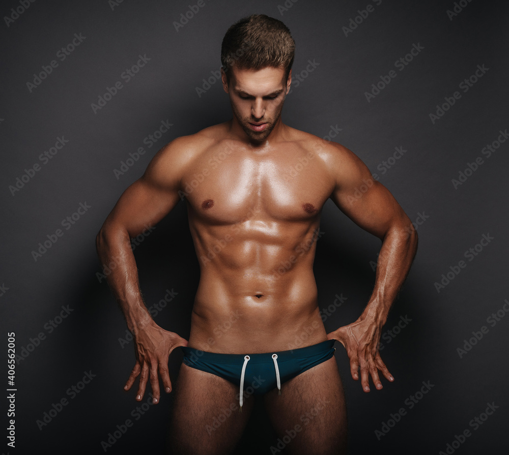 Handsome man in swimsuit. Male model in studio. Sexy guy in briefs. Handsome man in swimsuit. Male model in studio. Sexy guy in briefs.