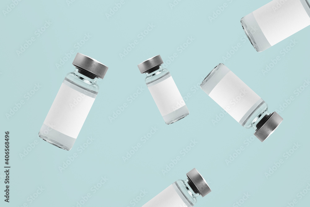 Falling injection vial glass bottles with white labels Falling injection vial glass bottles with white labels