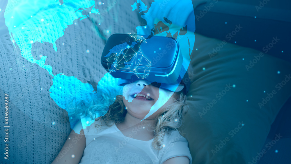 Fototapeta Little girl watching a movie through VR goggles