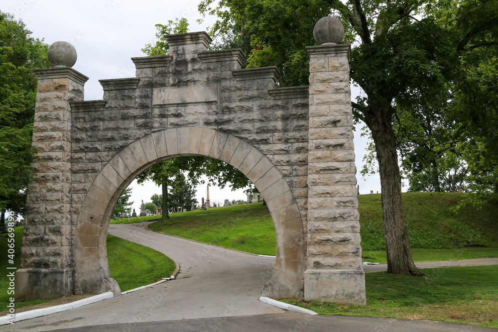 old cemetery graveyard memorial park entrance with historic stone arch