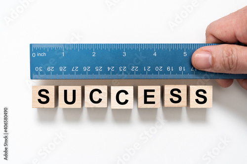 Canvas Print Measure success word using blue ruler, representing a review, evaluation or asse