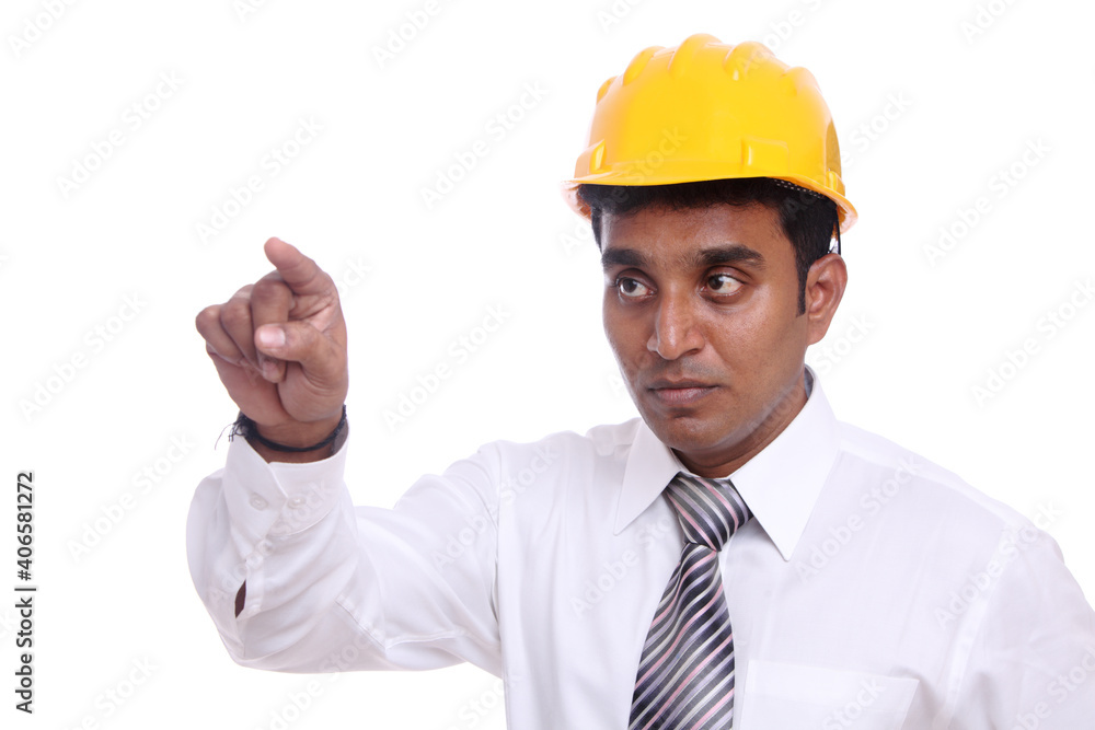Young Indian architect pointing to the camera on white background.