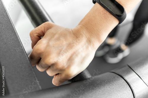 Close up of woman on treadmill. Concept of woman body part and workout.