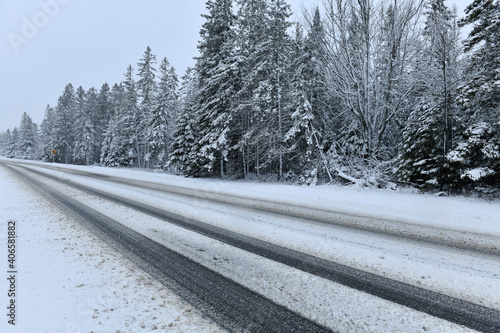 Snowy road after snowstorm in upstate New York where roads become dangerous when covered with snow and ice