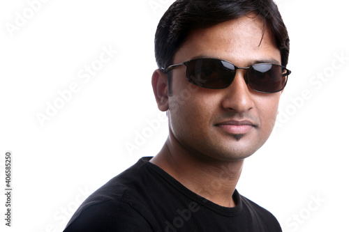 Indian young man posing in casual dress on white.