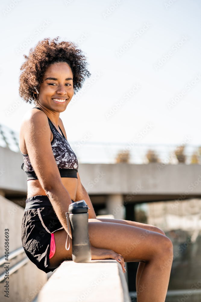 Athlete woman relaxing after work out outdoors.