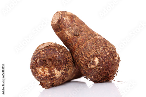 Fresh whole taro root over white background photo