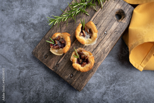 Brie bites with jam and nuts in crescent dough, mini appetizer dessert with cranberry or any jelly