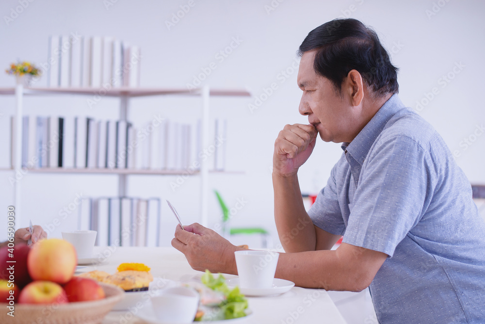 asian elder ponder his problem alone in the living room asian elder ponder his problem alone in the living room