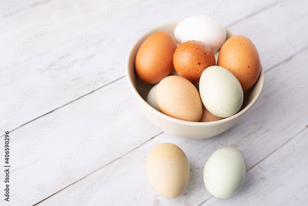 Fresh eggs from free range chickens on a small farm, beautiful colorful eggs from different breeds of chickens Fresh eggs from free range chickens on a small farm, beautiful colorful eggs from different breeds of chickens