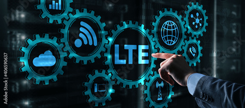 LTE concept on Server Room Background. Young business man presses with a finger LTE. photo