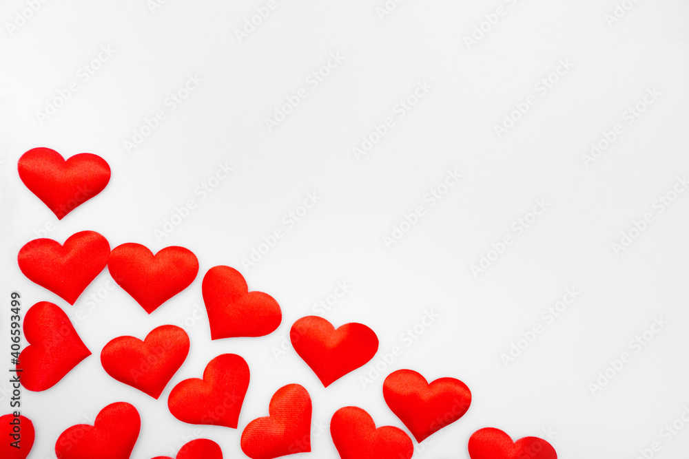 Many textured red hearts on top of each other on a white or gray background: place for text, St. Valentine's Day background, minimalism Many textured red hearts on top of each other on a white or gray background: place for text, St. Valentine's Day background, minimalism