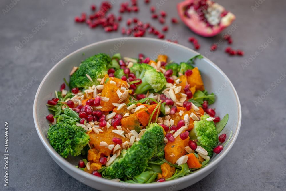healthy tasty Broccoli salad with pomegranate on a table healthy tasty Broccoli salad with pomegranate on a table
