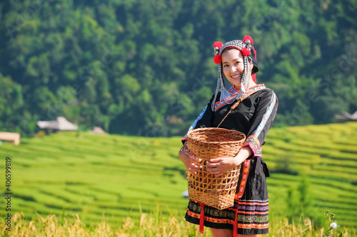 A beautiful farmer girl with straw in rice fields in northern Thailand