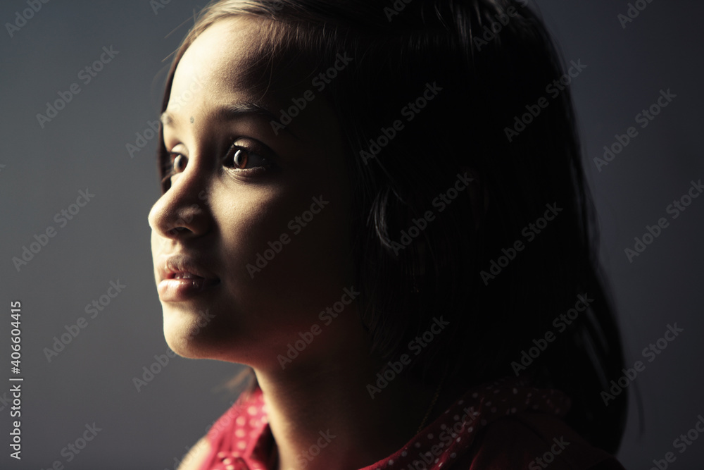 Fototapeta premium Low light portrait of Indian teen girl