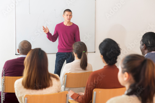 Teacher is giving lecture for students in the class