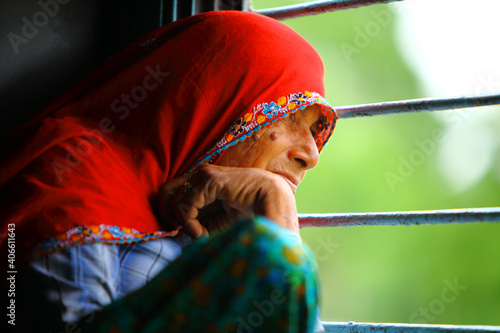 Canvas Print Old Indian women traveling in train alone.