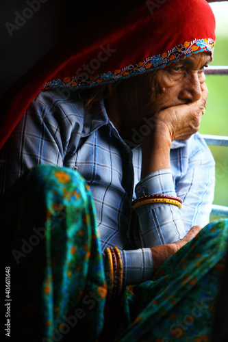 Photography Old Indian women traveling in train alone.