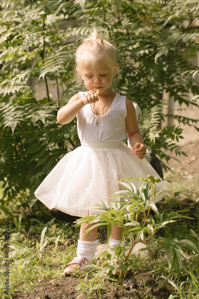 Little girl ballerina in the garden