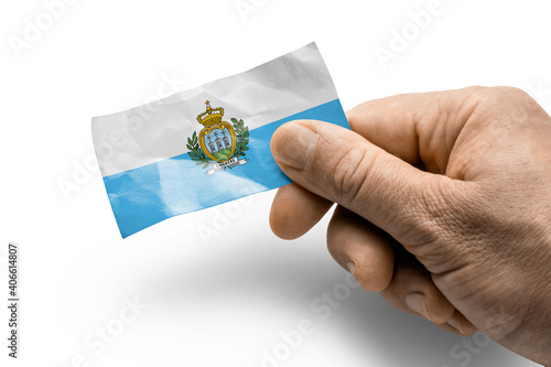 Hand holding a card with a national flag the San Marino photo