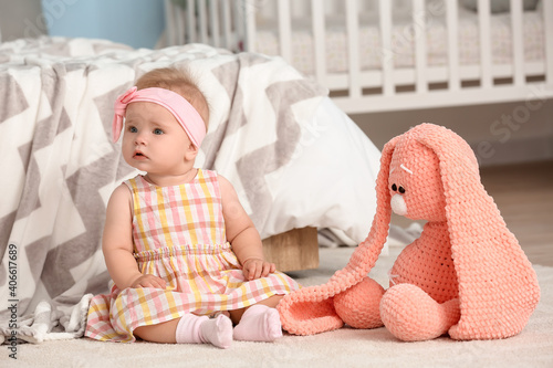 Cute little baby sitting on...