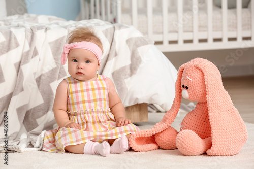 Cute little baby sitting on...
