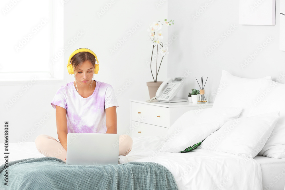 Beautiful young woman with headphones and laptop at home Beautiful young woman with headphones and laptop at home