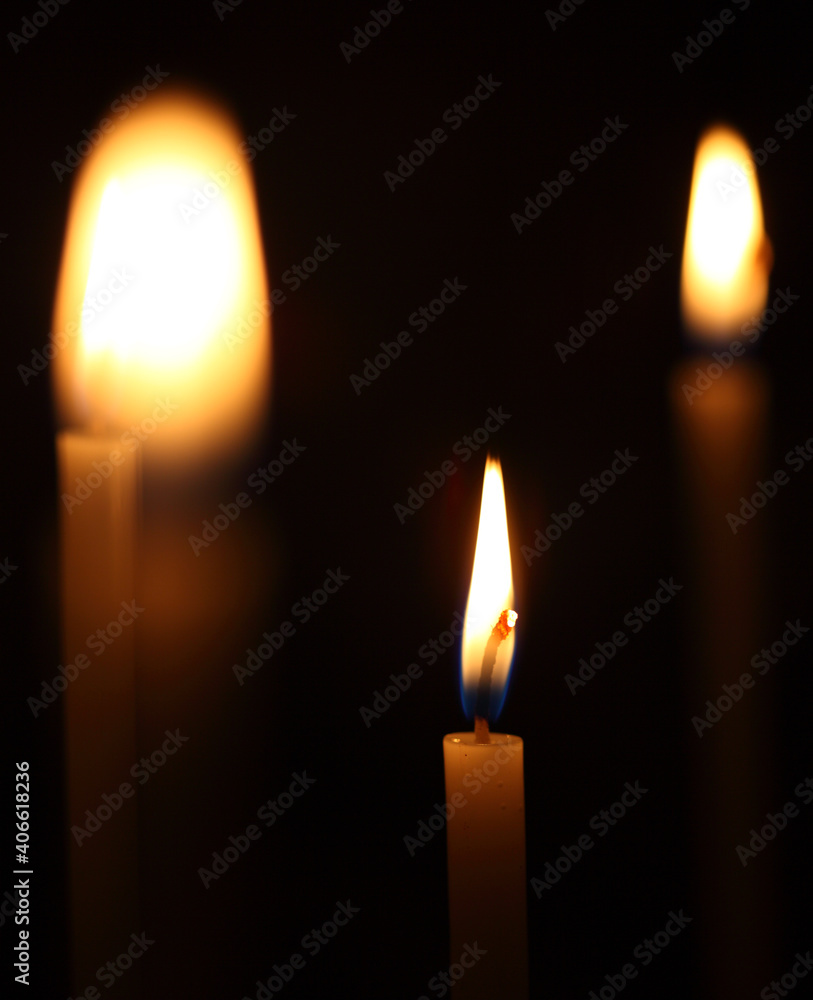 Closeup of burning candles on dark background. Closeup of burning candles on dark background.