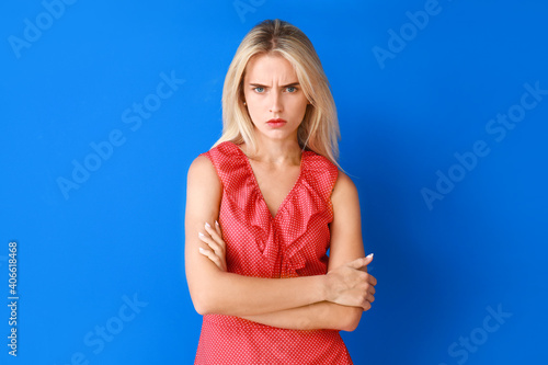 Angry young woman on color background