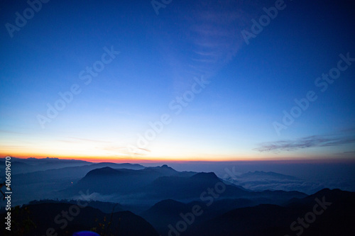 Sunrise over the mountains standing in fog on the island of Sri Lanka.