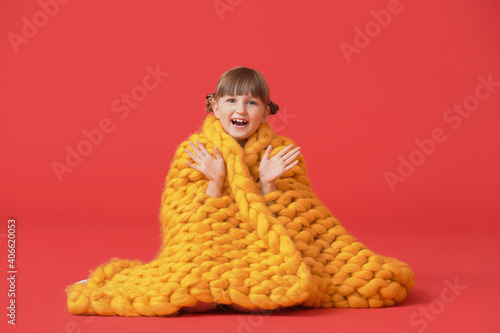 Happy little girl with warm...