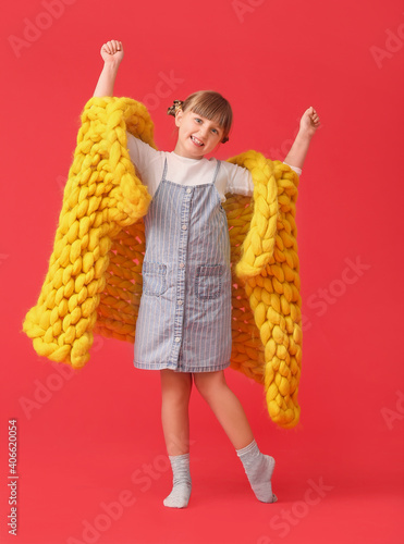 Happy little girl with warm...