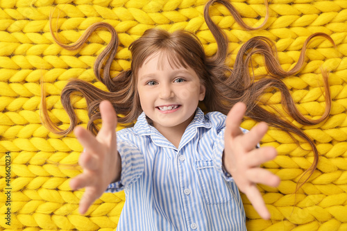 Happy little girl lying on ...