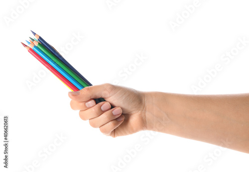 Female hand with colorful pencils on white background