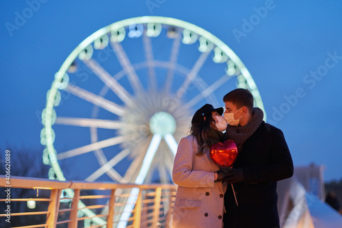 Happy couple celebrating Valentines Day in masks during covid-19 pandemic