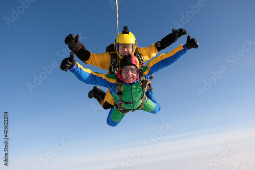 Skydiving. Tandem jump. Two guys are flying in the sky.