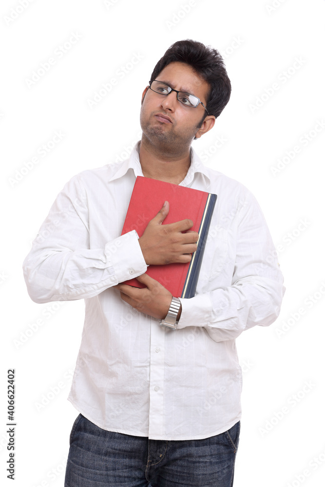 Indian young man thinking with book isolated on white. Indian young man thinking with book isolated on white.