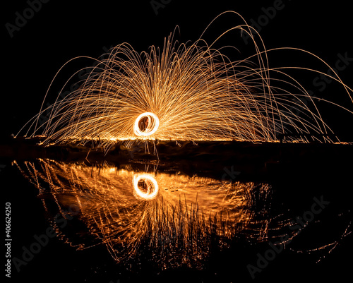 light painting over water with reflections