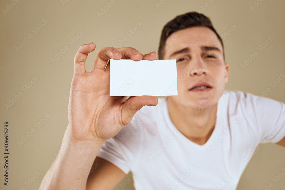 Man with a business card in the hands of an office manager beige background Copy Space