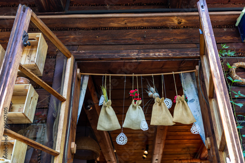 Linen pouches with medicinal herbs hanging in the window of the house