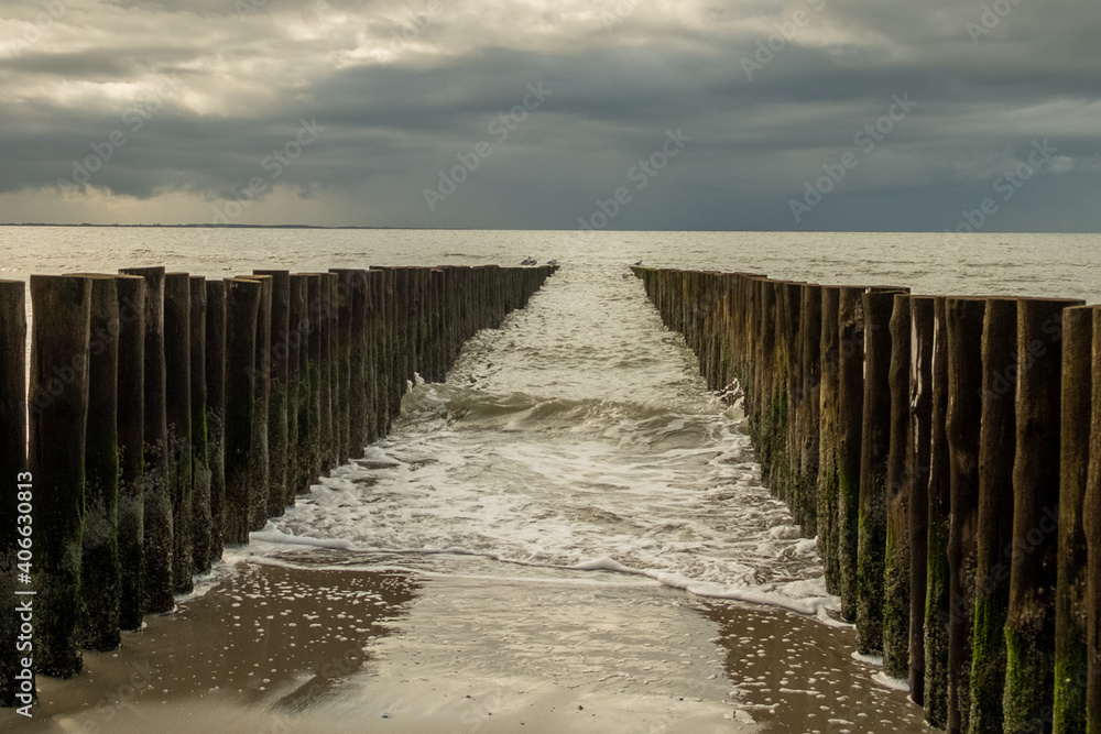 Breakwaters and waves of seawater in Zeeland, Netherlands.