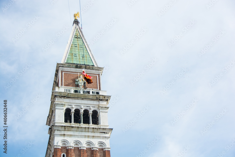 Venice, Italy. February 16, 2020: Flight of the Angel ceremony (Il Volo dell'Angelo) at Venice Carnival (Carnivale di Venezia). Woman descends from the Bell Tower to a soft landing at St Mark's Square
